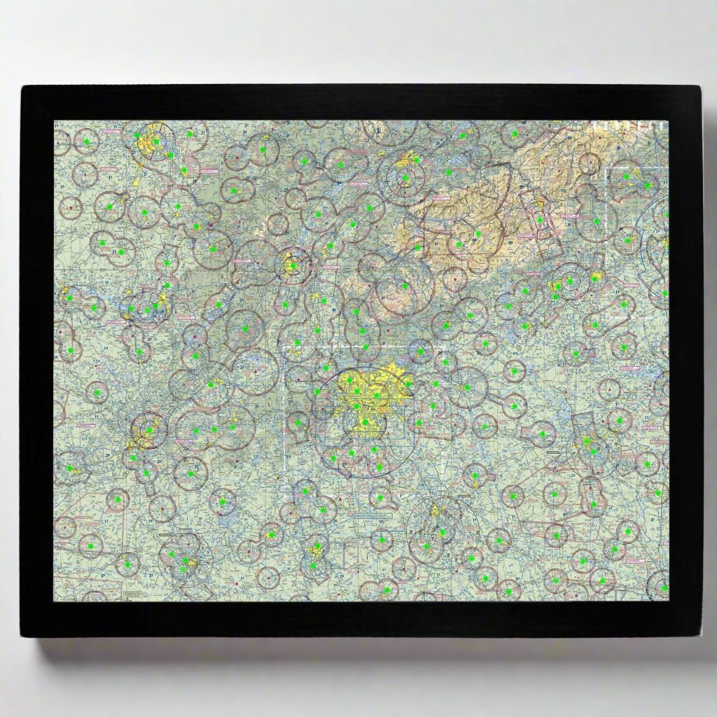 Image of the LightMap Air with black frame mounted on a wall showing live weather and METAR conditions