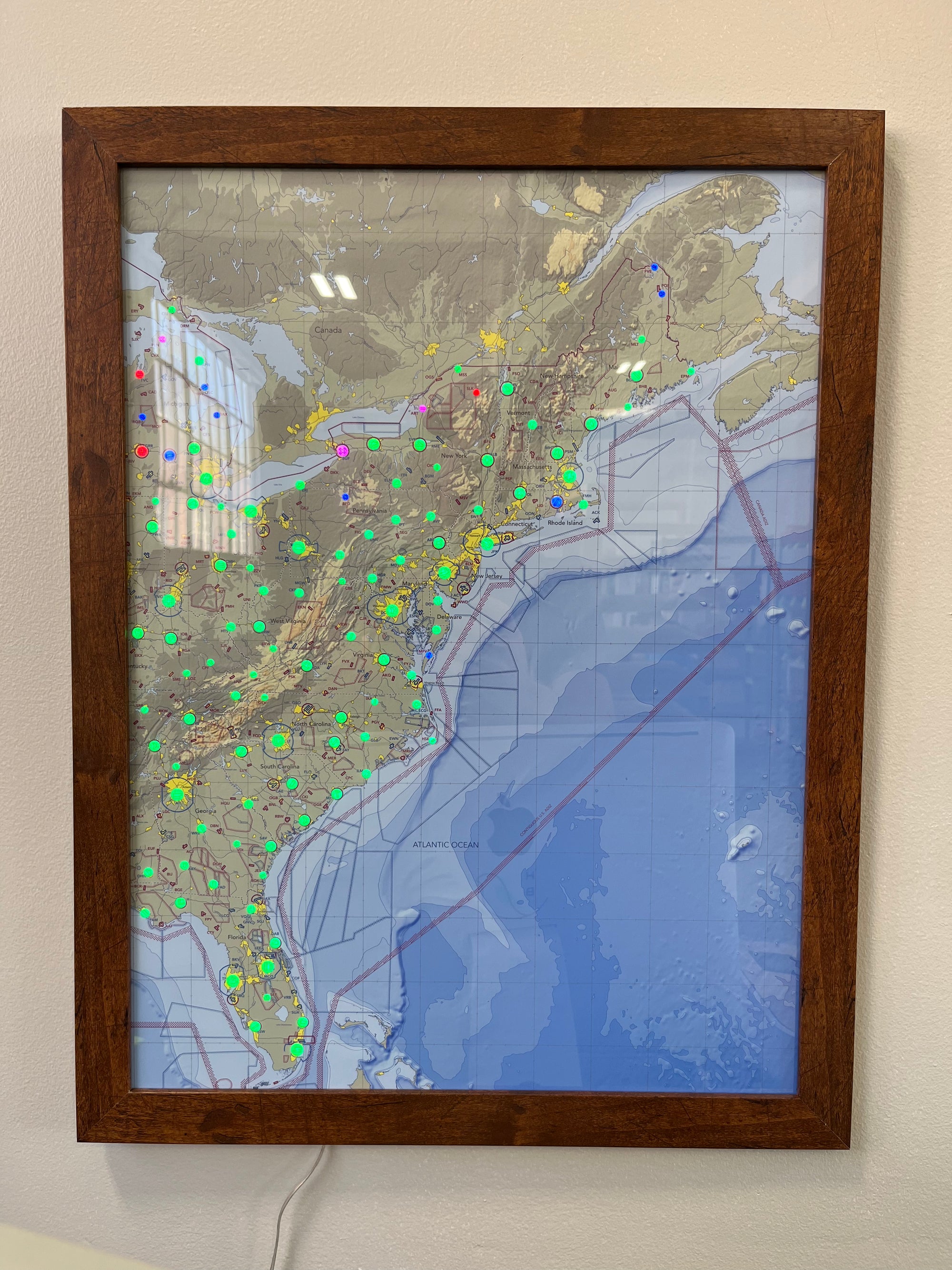 Image of the LightMap AIR USA showing the eastern US with live weather and METAR conditions. Artwork is mounted in a cherry frame.