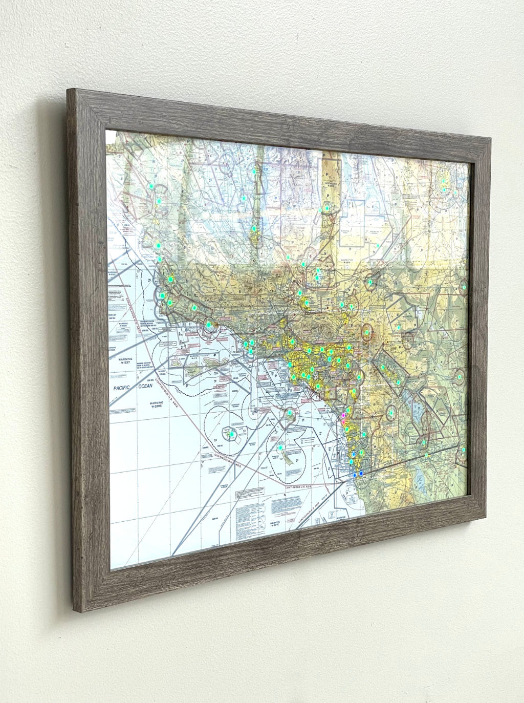 Image of the LightMap Air showing live weather and METAR conditions in a driftwood frame at an angle