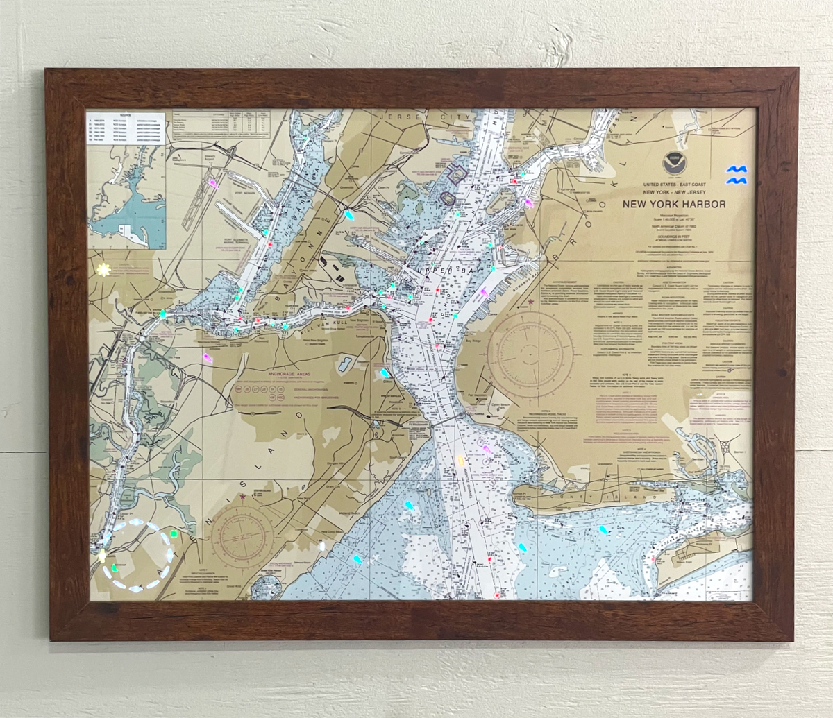 Image of the LightMap Sea showing the NYC harbor and illuminated with live wind, weather, tide, buoys, and lighthouses. Mounted in a cherry frame.